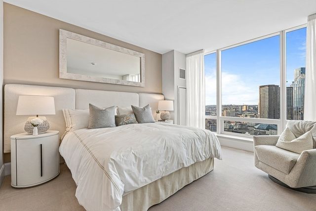 a bedroom with bed and a large window