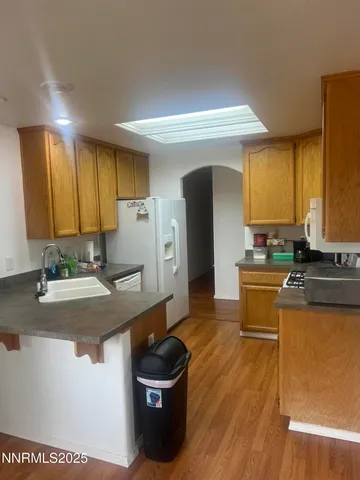 a kitchen with stainless steel appliances granite countertop a sink a stove counter space and cabinets