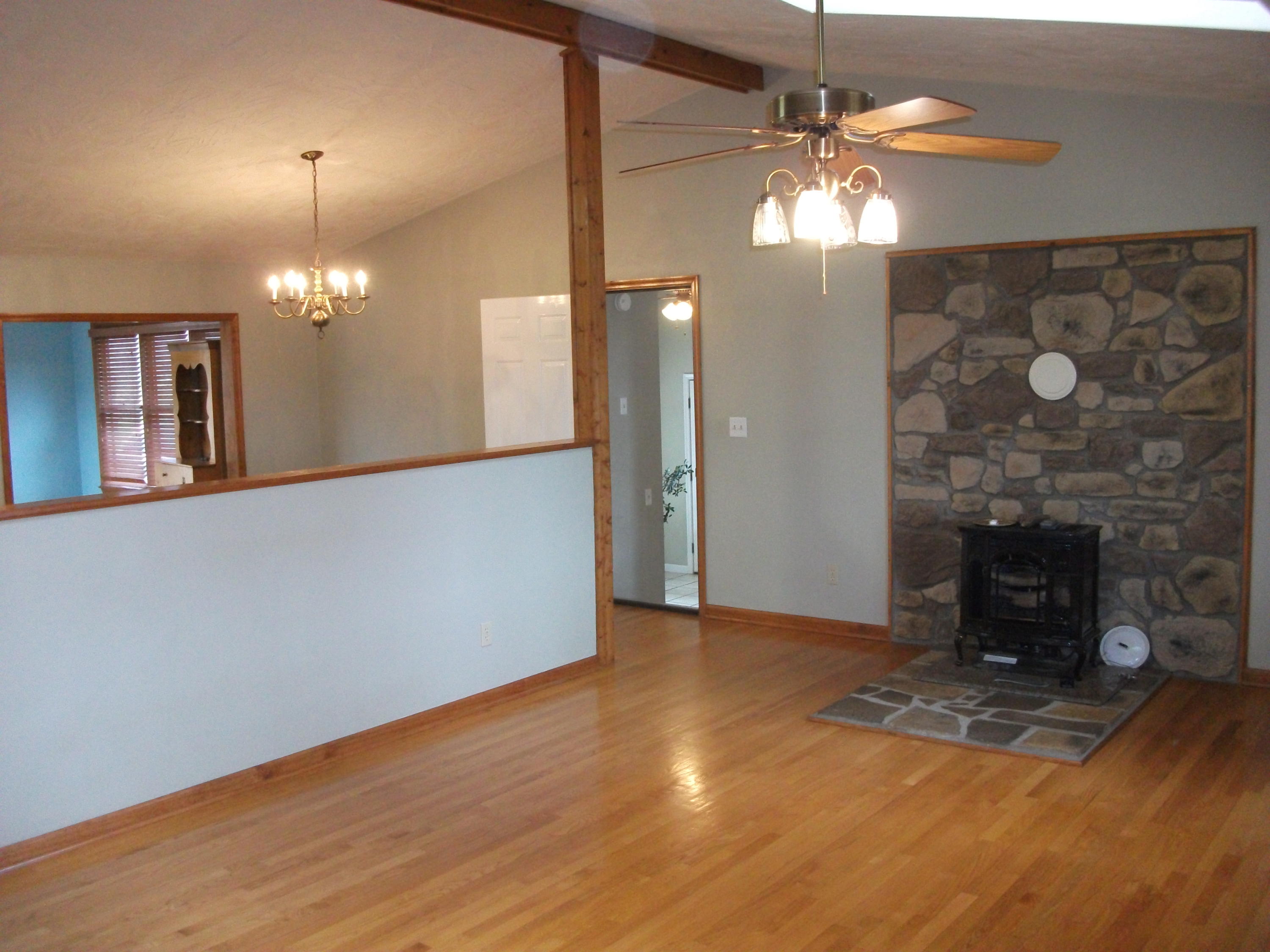 726 Swenfield Road Callaway, VA 24067 - Photo 3 of 40 a view of a livingroom with a fireplace a chandelier and wooden floor