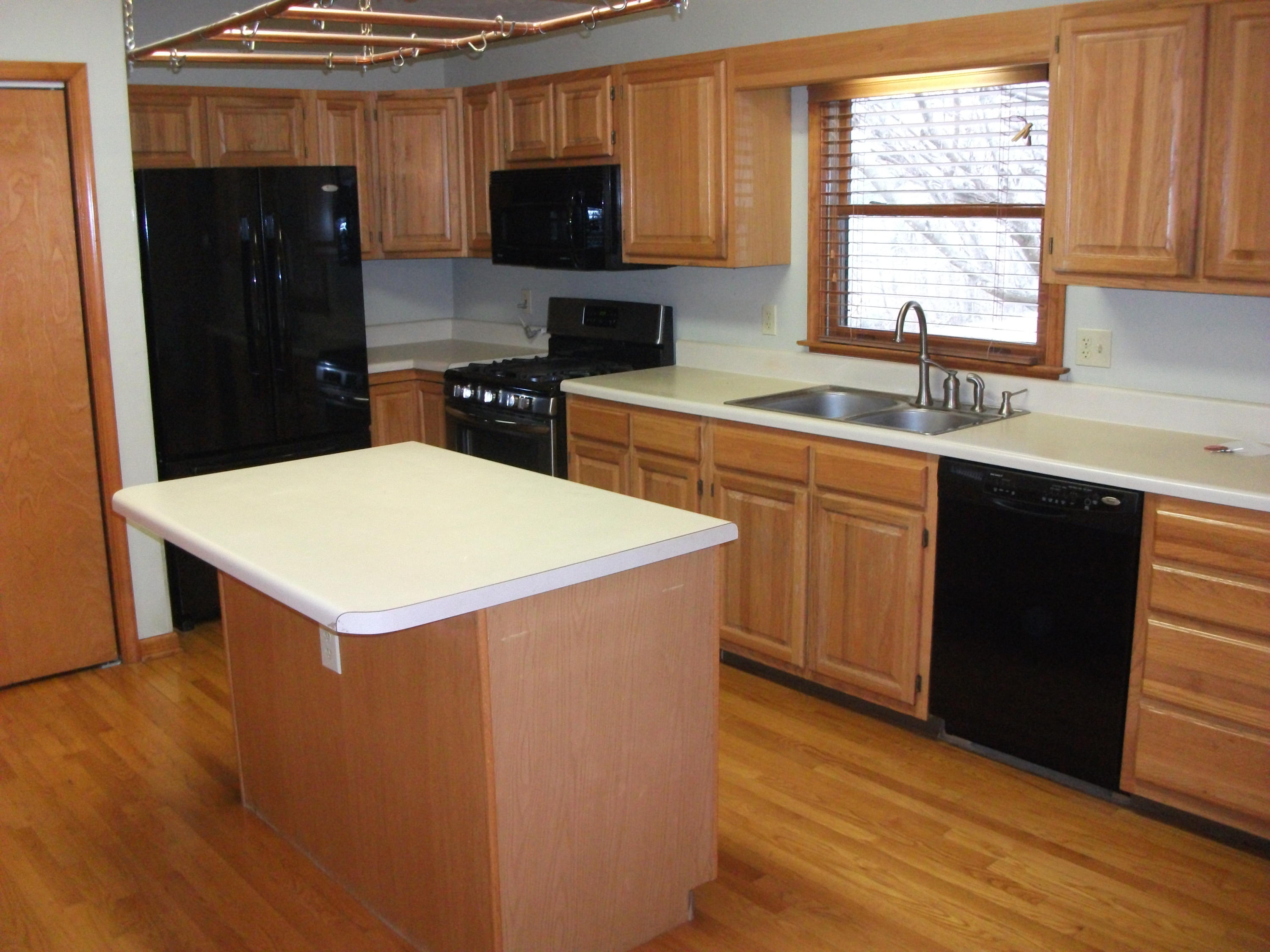 726 Swenfield Road Callaway, VA 24067 - Photo 7 of 40 a kitchen with stainless steel appliances a stove a sink a microwave and wooden cabinets