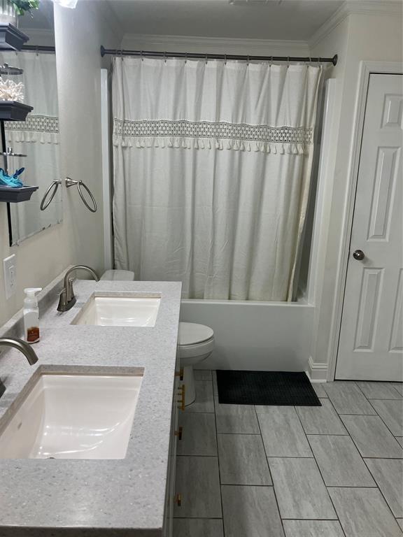 233 Church Road Stonewall, LA 71078 - Photo 17 of 32 Full bathroom with shower / bathtub combination with curtain, double vanity, crown molding, and light tile patterned floors