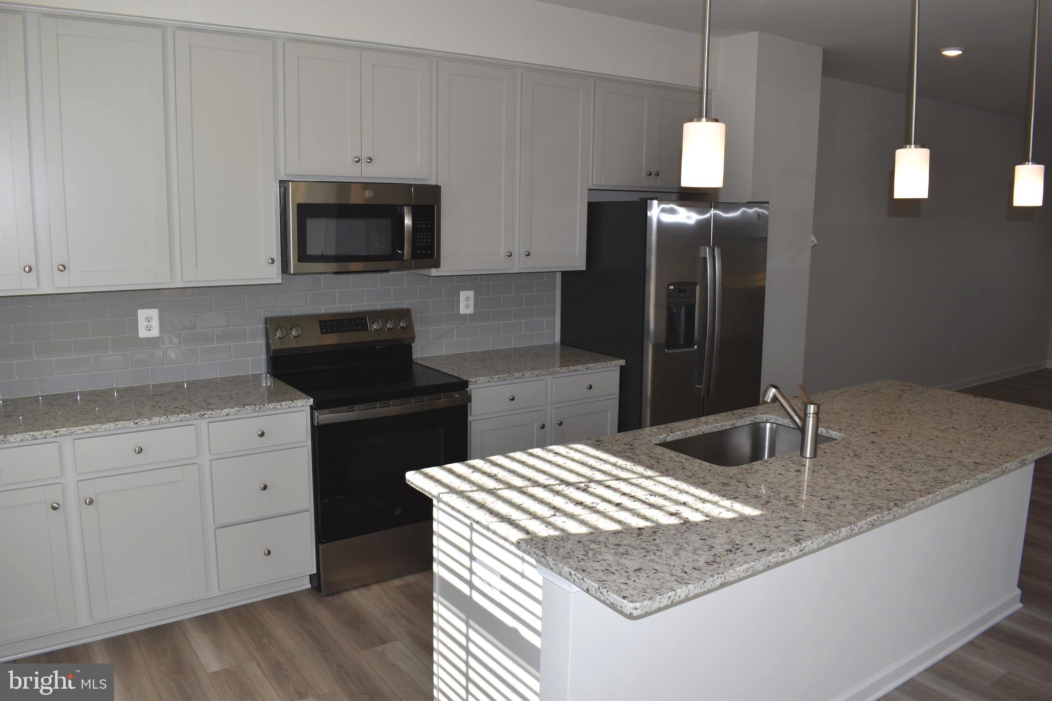 224 Swan Fld Avenue Ranson, WV 25438 - Photo 11 of 34 a kitchen with stainless steel appliances granite countertop a sink a stove and a refrigerator