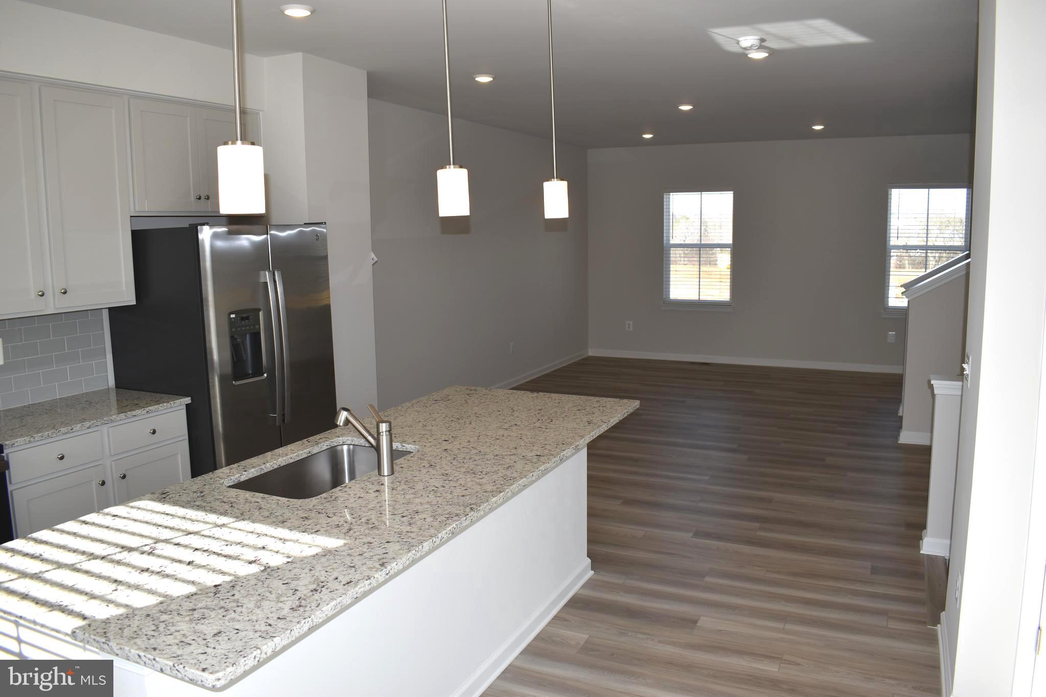 224 Swan Fld Avenue Ranson, WV 25438 - Photo 12 of 34 a kitchen with a sink chandelier and wooden floor