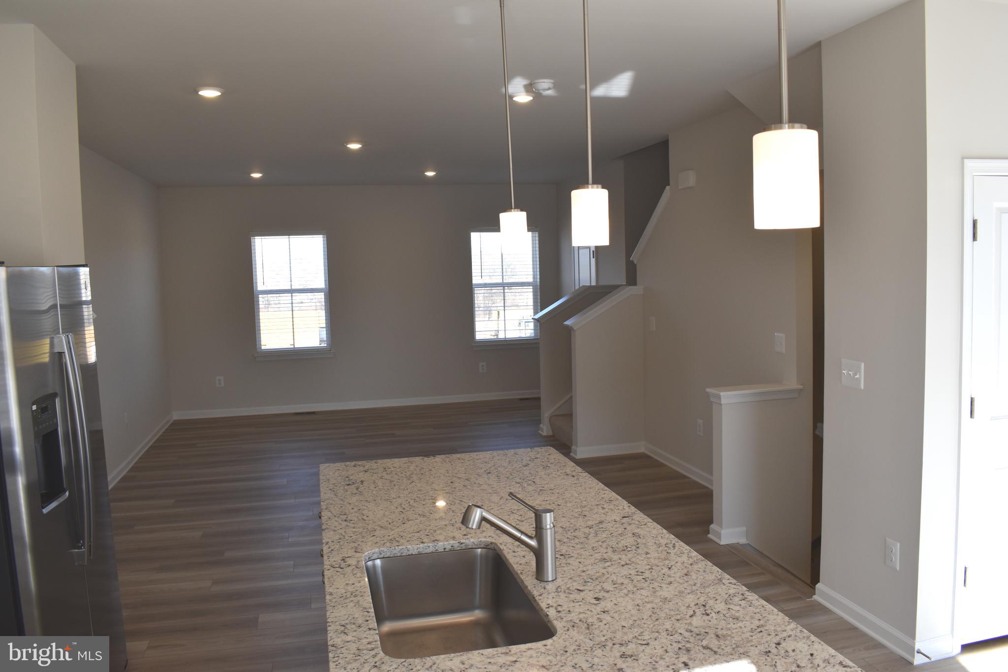 224 Swan Fld Avenue Ranson, WV 25438 - Photo 15 of 34 a view of a hallway with wooden floor and a bathroom