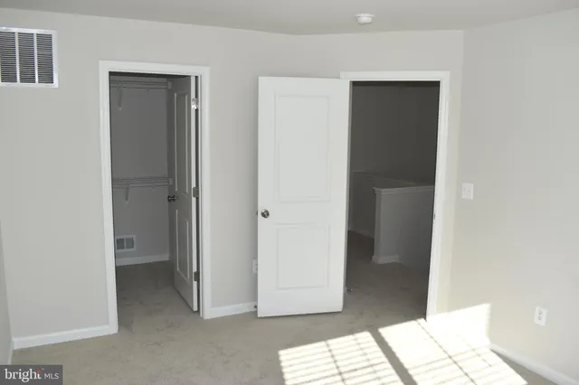 a view of bathroom with a sink and a mirror