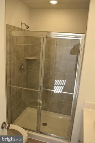a bathroom with a glass shower door