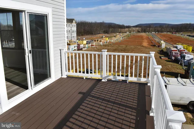 a view of a balcony with wooden floor and city view