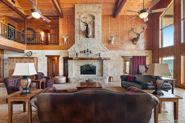 a living room with fireplace furniture and a floor to ceiling window