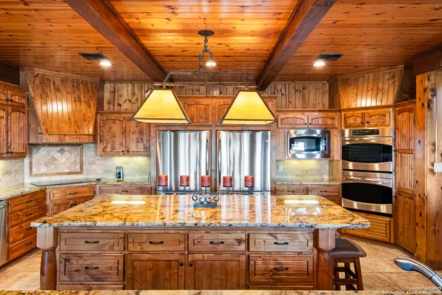 a bathroom with a granite countertop sink mirror vanity and toilet