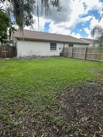 a view of a house with a yard and sitting area