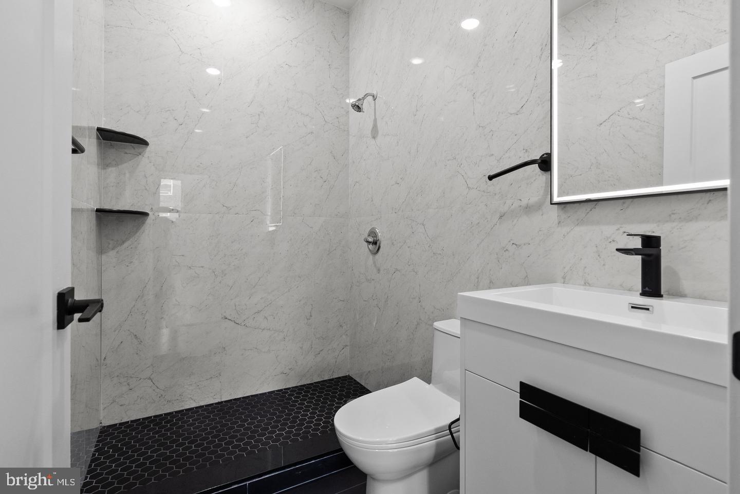 2146 North Front Street Philadelphia, PA 19122 - Photo 14 of 39 a bathroom with a sink a toilet a shower and mirror