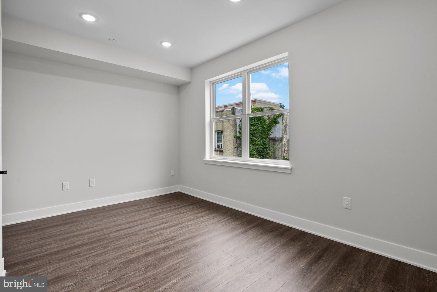 2146 North Front Street Philadelphia, PA 19122 - Photo 22 of 39 a view of an empty room with wooden floor and a window