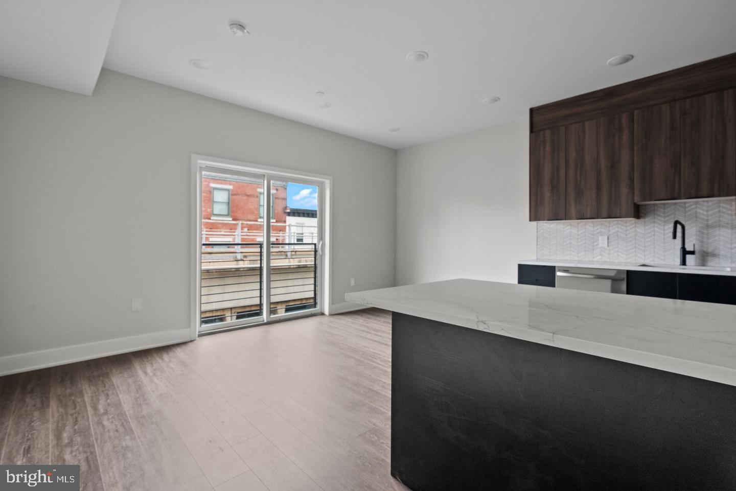 2146 North Front Street Philadelphia, PA 19122 - Photo 26 of 39 a kitchen with stainless steel appliances a sink dishwasher a stove and a refrigerator with wooden floor