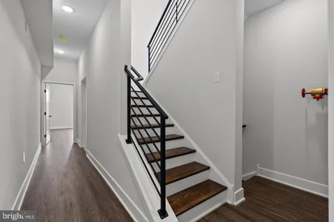 a view of a hallway with wooden floor and entryway