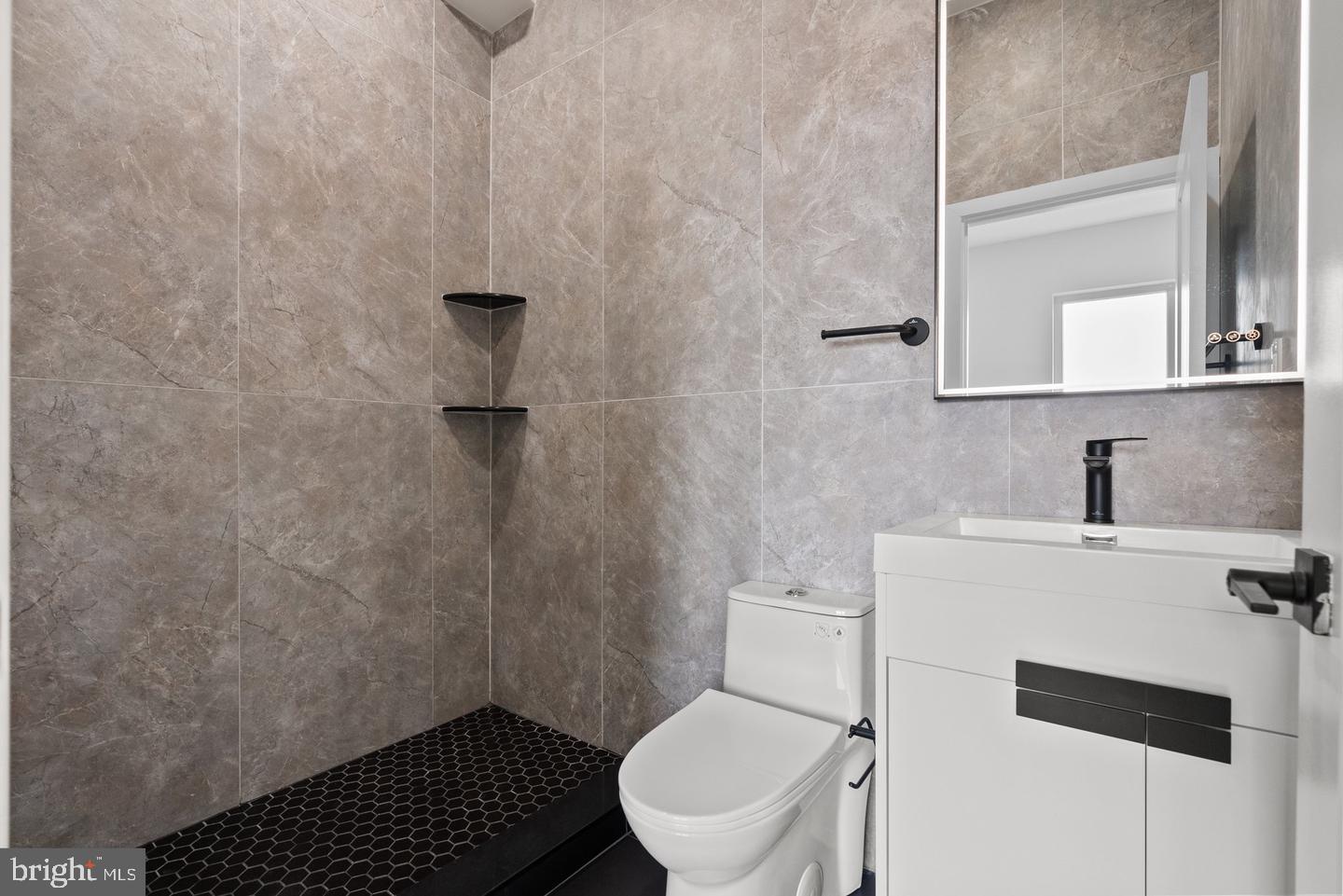 2146 North Front Street Philadelphia, PA 19122 - Photo 33 of 39 a bathroom with a toilet a sink and mirror