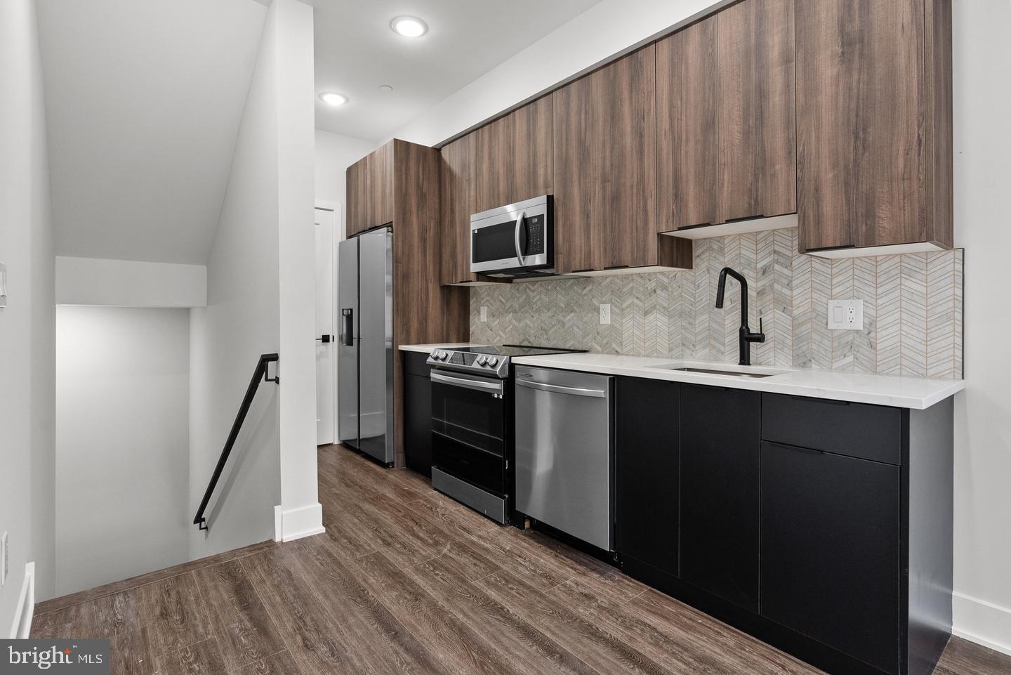 2146 North Front Street Philadelphia, PA 19122 - Photo 4 of 39 a kitchen with a sink a microwave a stove and refrigerator