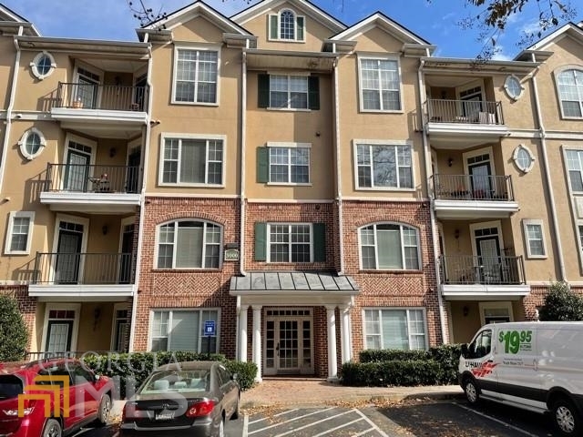 3203 Stratford Commons Decatur, GA 30033 - Photo 1 of 1 a front view of a building with a lot of cars parked on road