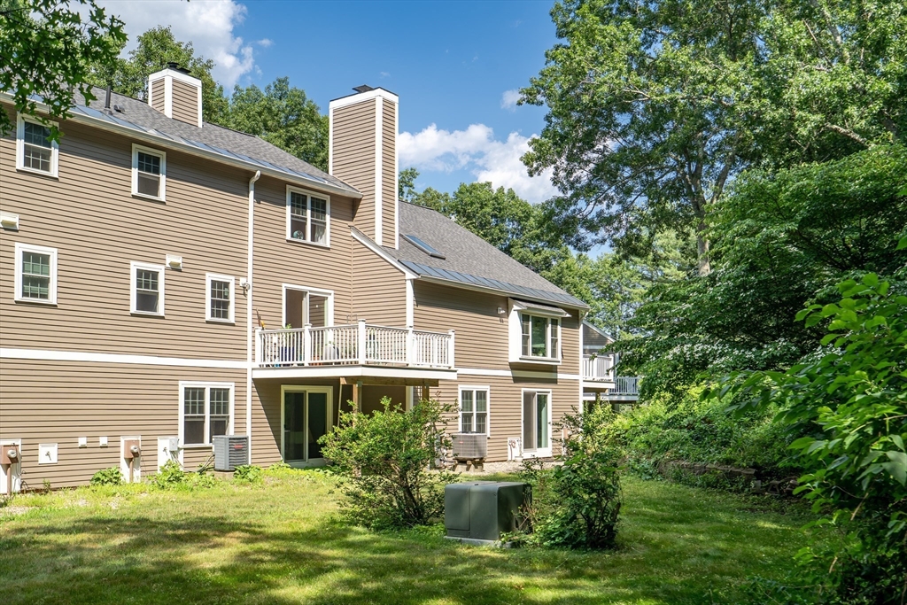 58 MacIntosh Lane, Unit 58 Boxborough, MA 01719 - Photo 3 of 23 a front view of a house with a garden