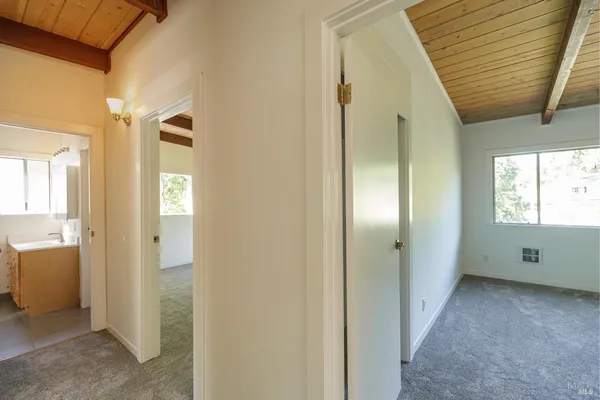 a view of a livingroom with wooden floor and windows
