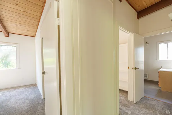 a view of a hallway with wooden shelves