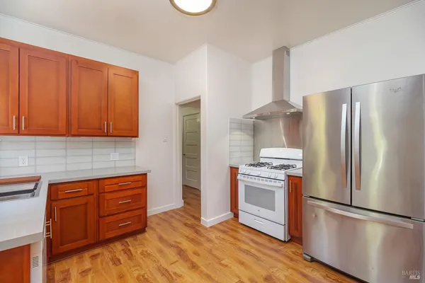 a kitchen that has a sink stove and cabinets