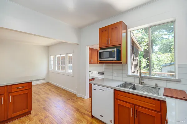 a room with a bed cabinets and wooden floor