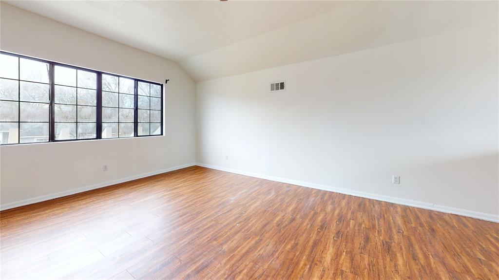 200 Chappell Street Terrell, TX 75160 - Photo 12 of 20 Spare room featuring light wood-type flooring and vaulted ceiling