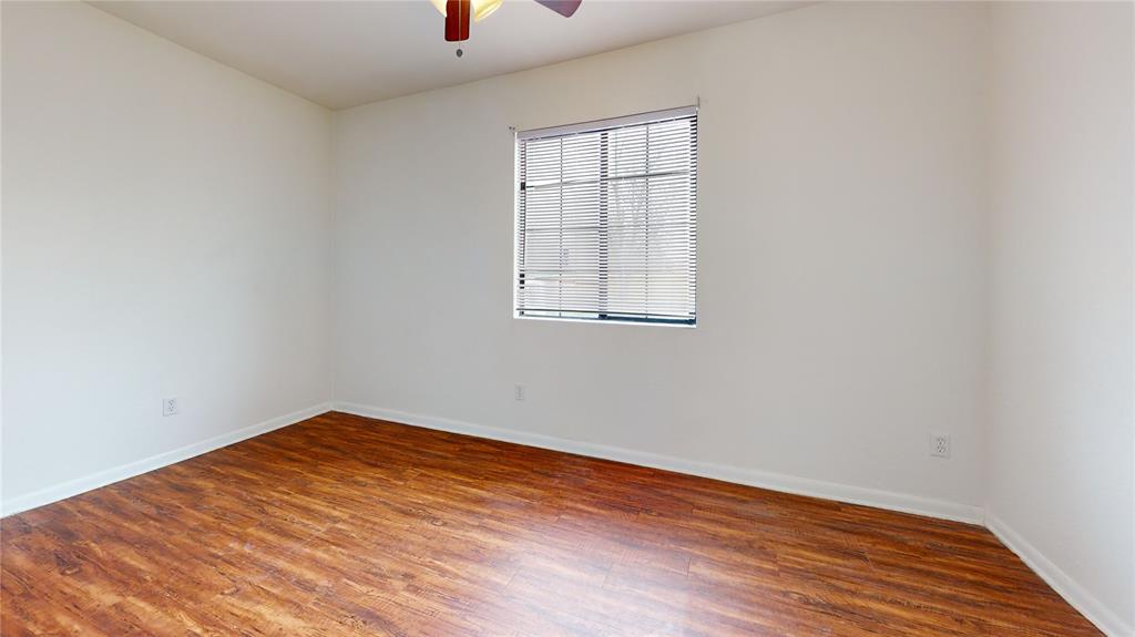 200 Chappell Street Terrell, TX 75160 - Photo 15 of 20 Unfurnished room featuring dark wood finished floors and a ceiling fan