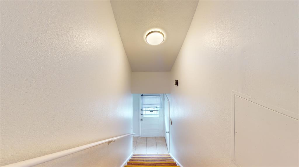 200 Chappell Street Terrell, TX 75160 - Photo 16 of 20 Stairway with a textured wall and wood finished floors