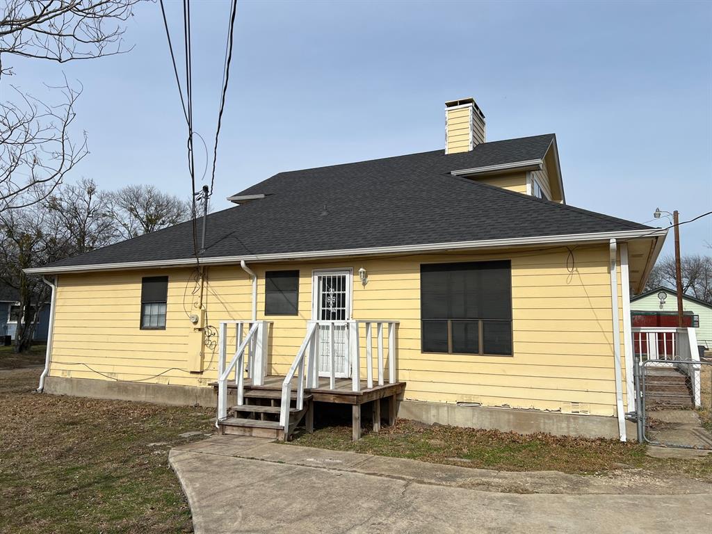 200 Chappell Street Terrell, TX 75160 - Photo 20 of 20 Rear view of property featuring a chimney, roof with shingles, and a gate