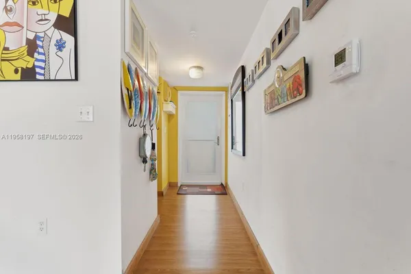 a view of a hallway with wooden floor