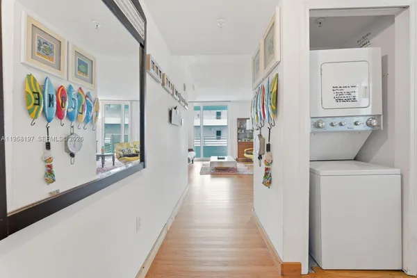 a view of a hallway with wooden floor and dining room