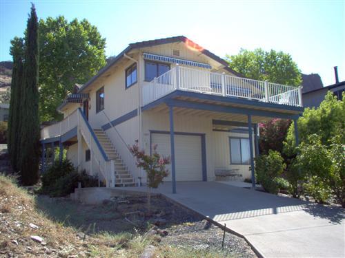 703 Poker Flat Road Copperopolis, CA 95228 - Photo 1 of 24 a front view of a house with garden