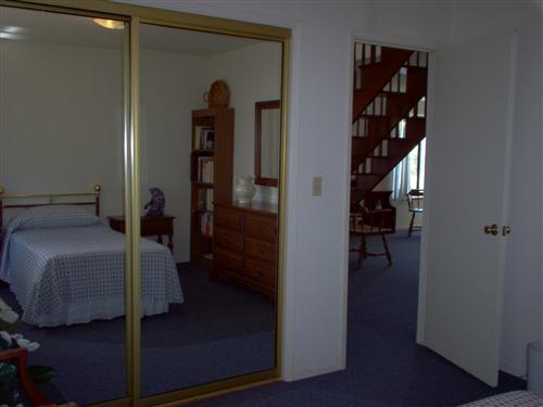 703 Poker Flat Road Copperopolis, CA 95228 - Photo 20 of 24 a bedroom with a bed and a hallway