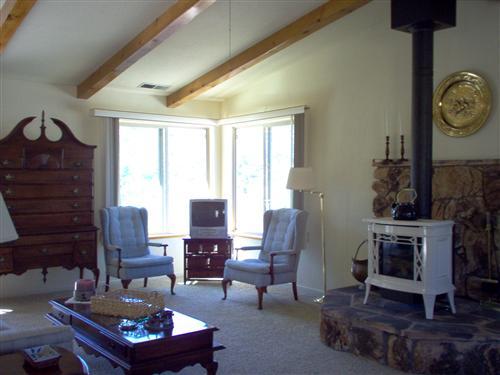 703 Poker Flat Road Copperopolis, CA 95228 - Photo 5 of 24 a living room with furniture a fireplace and a table
