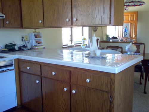 703 Poker Flat Road Copperopolis, CA 95228 - Photo 7 of 24 a kitchen with stainless steel appliances granite countertop wooden cabinets a sink and dishwasher