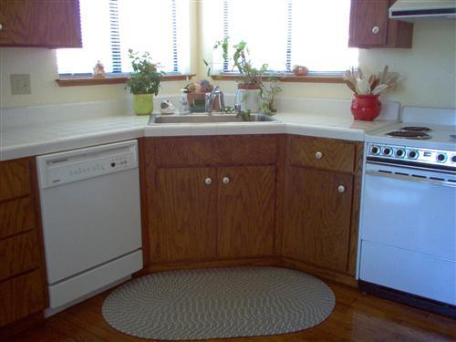 703 Poker Flat Road Copperopolis, CA 95228 - Photo 8 of 24 a kitchen with a sink cabinets and wooden floor