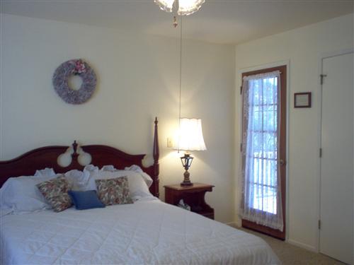703 Poker Flat Road Copperopolis, CA 95228 - Photo 9 of 24 a bedroom with a bed and a chandelier