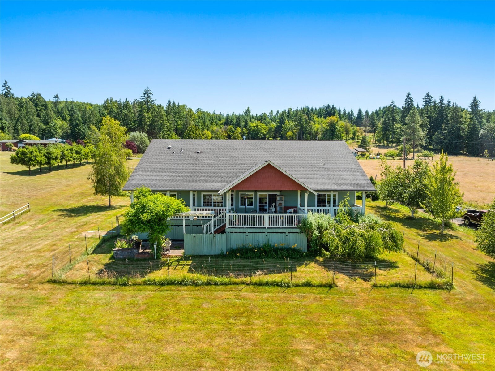225 Maw Road Toledo, WA 98591 - Photo 1 of 34 a front view of a house with a yard table and chairs