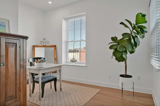 a table with a potted plant and a window