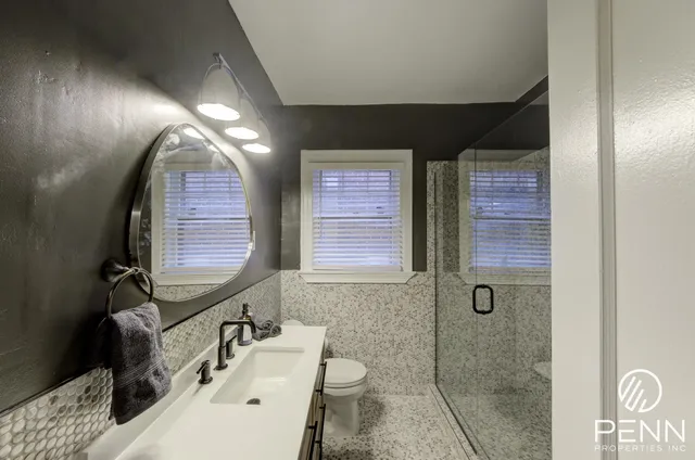 a bedroom with a bed and a mirror