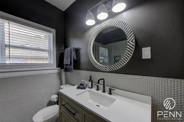 a living room with furniture a rug and a clock