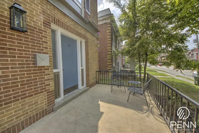 a view of a patio with two couches and deck with wooden floor and fence