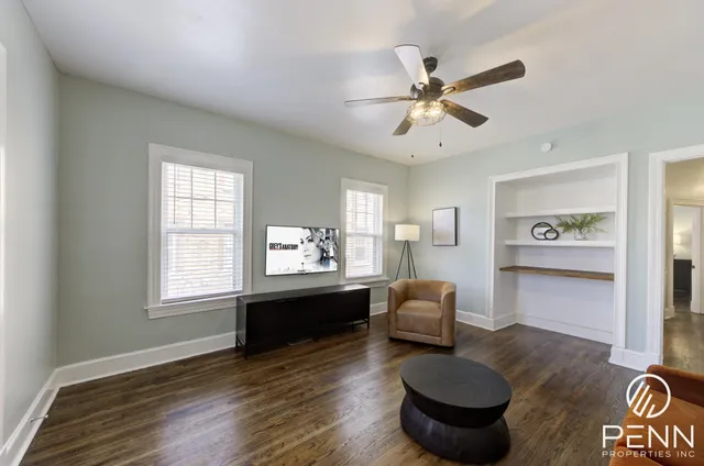 a living room with furniture window and wooden floor