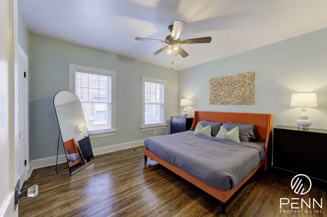 a bedroom with a bed a chandelier and a window
