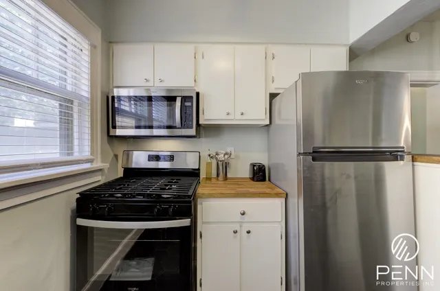 a kitchen with a refrigerator stove and cabinets