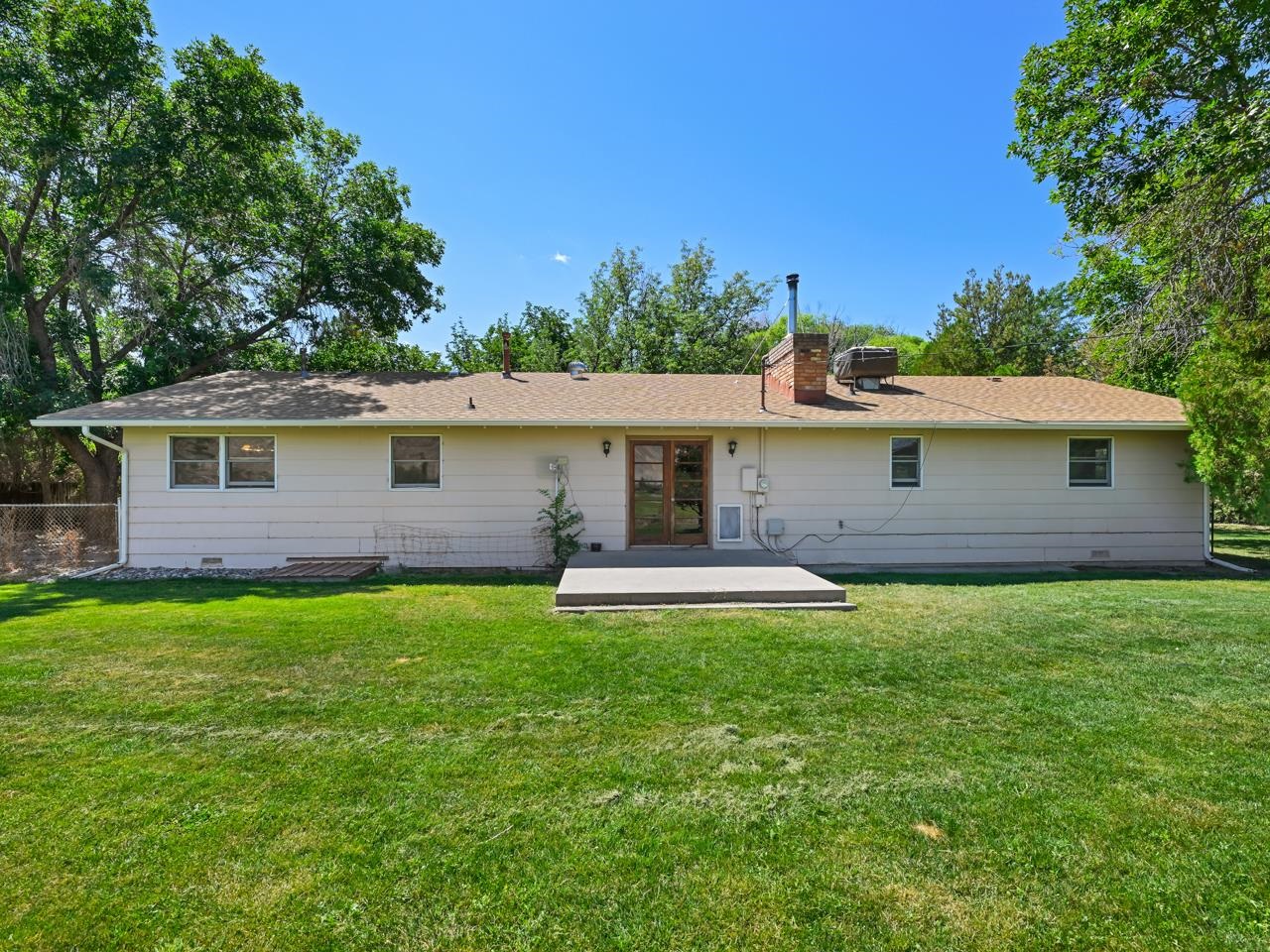 3418 F Road Clifton, CO 81520 - Photo 23 of 41 a front view of a house with a yard and porch
