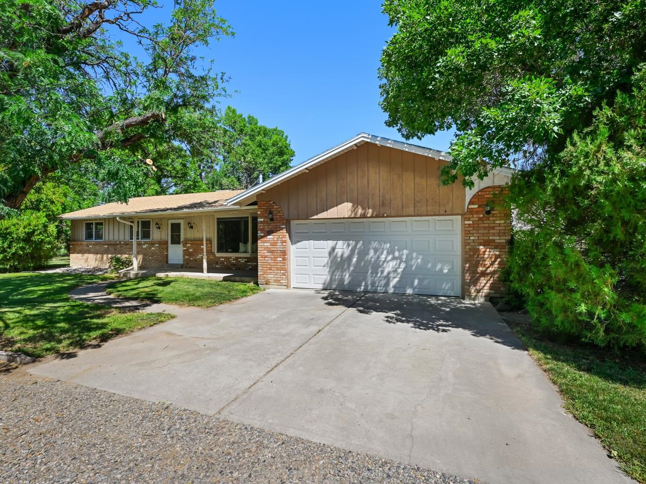3418 F Road Clifton, CO 81520 - Photo 3 of 41 a front view of a house with a yard and garage