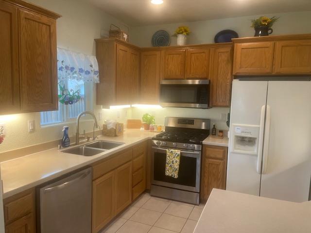 812 Vía Rosa Los Banos, CA 93635 - Photo 13 of 18 a kitchen with stainless steel appliances a stove a sink and a refrigerator