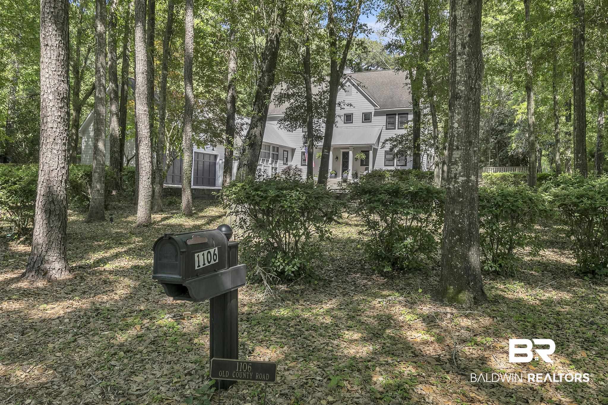 1106 Old County Road Daphne, AL 36526 - Photo 66 of 66 Wooded exterior featuring mature trees, a multi-story residence, and an attached garage